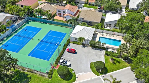 an aerial view of a tennis ground and a yard