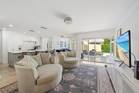 a living room with furniture a large window and a flat screen tv