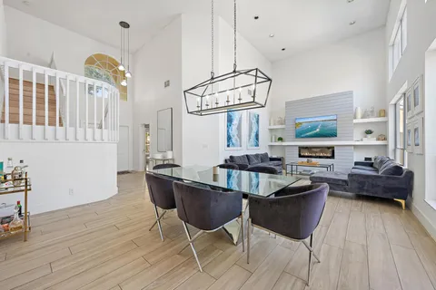 a living room with furniture a chandelier and a wooden floor