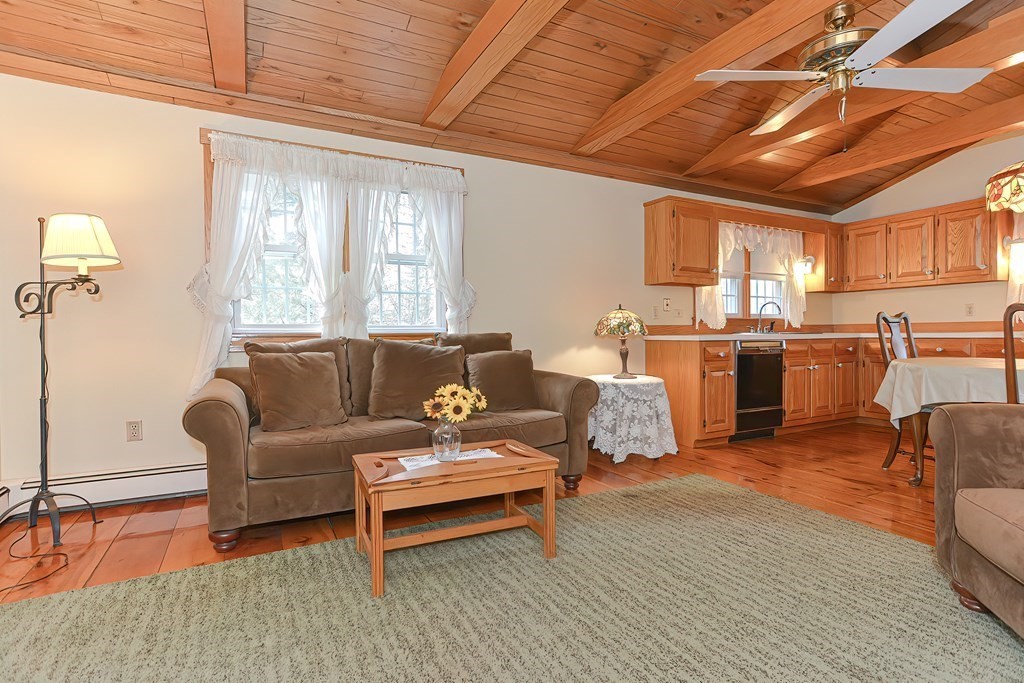 142 Middleboro Road Freetown, MA 02717 - Photo 13 of 42 a living room with furniture a kitchen view and a kitchen island