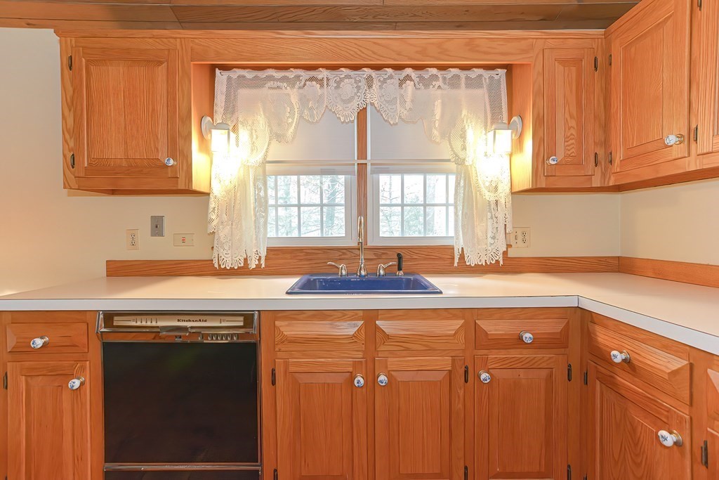142 Middleboro Road Freetown, MA 02717 - Photo 19 of 42 a kitchen with stainless steel appliances granite countertop a sink and a white cabinets