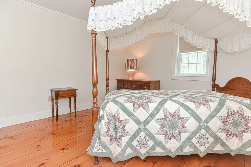 142 Middleboro Road Freetown, MA 02717 - Photo 35 of 42 a bedroom with a bed and a chandelier