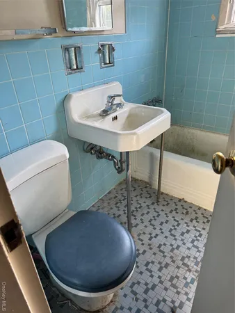 a bathroom with a sink toilet and mirror