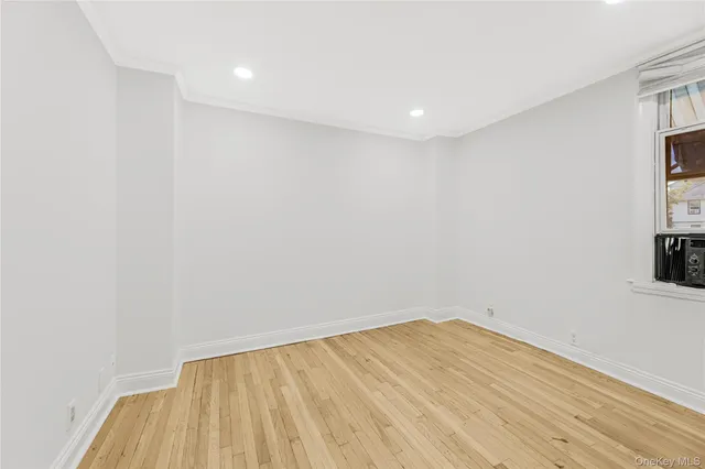 a view of room with wooden floor and fan