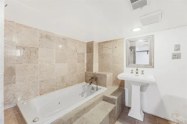 a bathroom with a bathtub and a sink