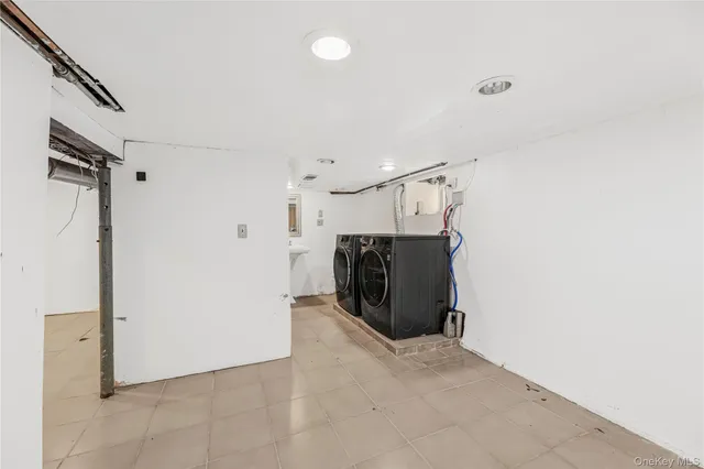 a view of a storage & utility room with refrigerator and windows
