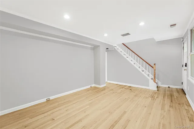 a view of hallway with wooden floor