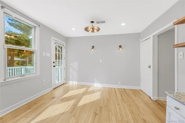 a view of a livingroom with wooden floor and window