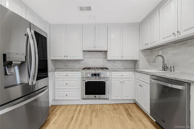 a kitchen with a sink stove and refrigerator