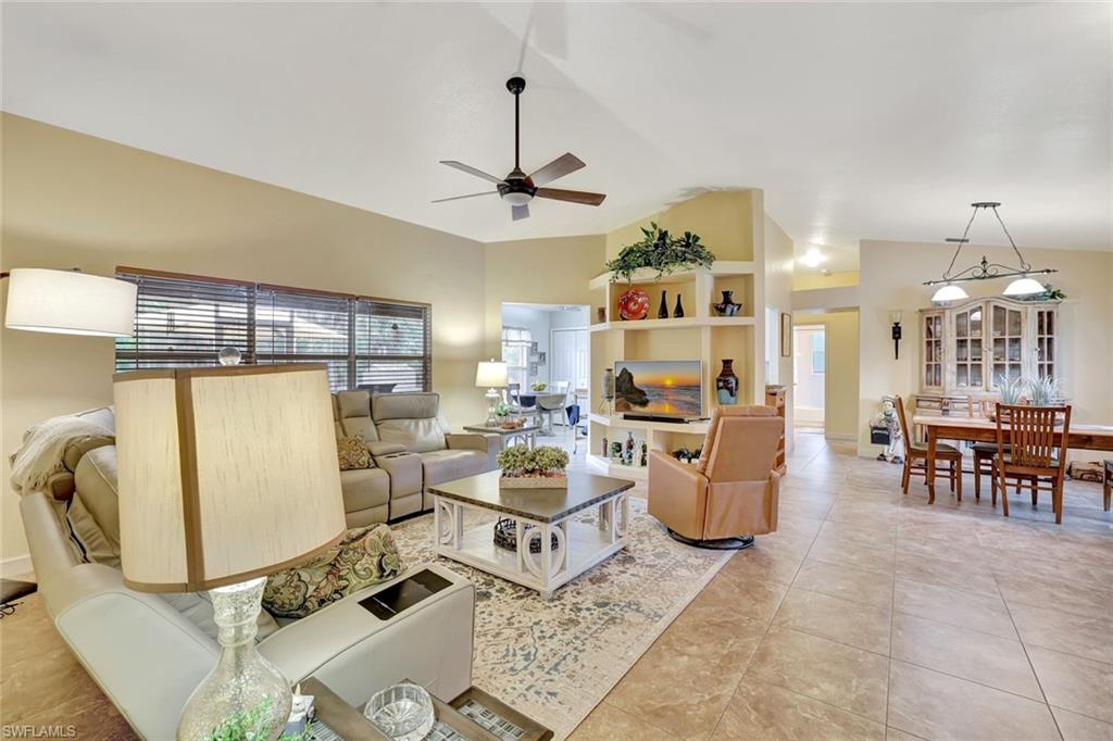 660 20th Street Southeast Naples, FL 34117 - Photo 3 of 17 Living room featuring ceiling fan, light tile patterned flooring, and high vaulted ceiling