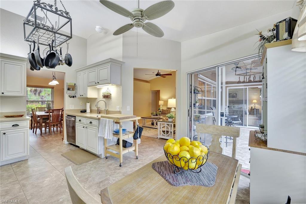 660 20th Street Southeast Naples, FL 34117 - Photo 5 of 17 Dining room featuring a ceiling fan, a towering ceiling, and a chandelier