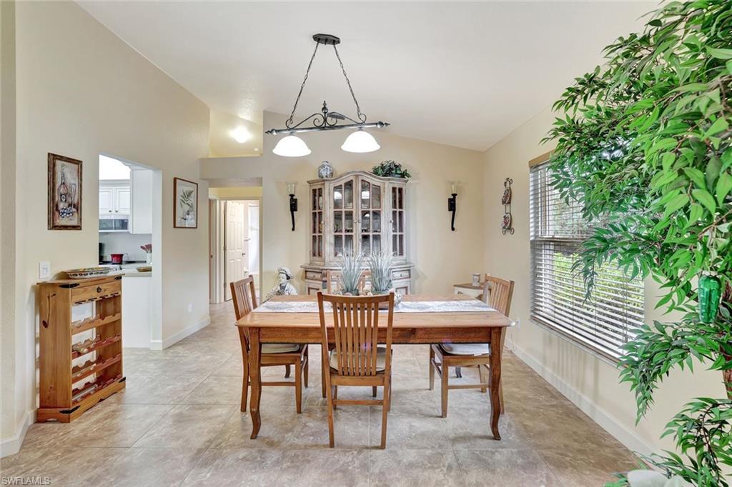 660 20th Street Southeast Naples, FL 34117 - Photo 6 of 17 Dining space featuring vaulted ceiling and baseboards