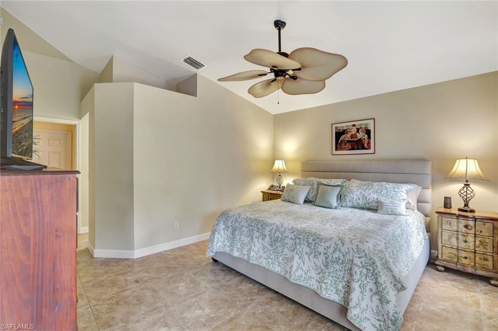 660 20th Street Southeast Naples, FL 34117 - Photo 7 of 17 Bedroom featuring vaulted ceiling and ceiling fan