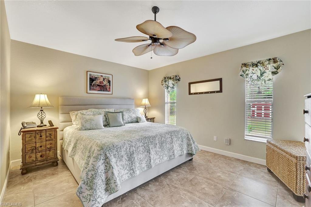 660 20th Street Southeast Naples, FL 34117 - Photo 8 of 17 Tiled bedroom featuring a ceiling fan and baseboards