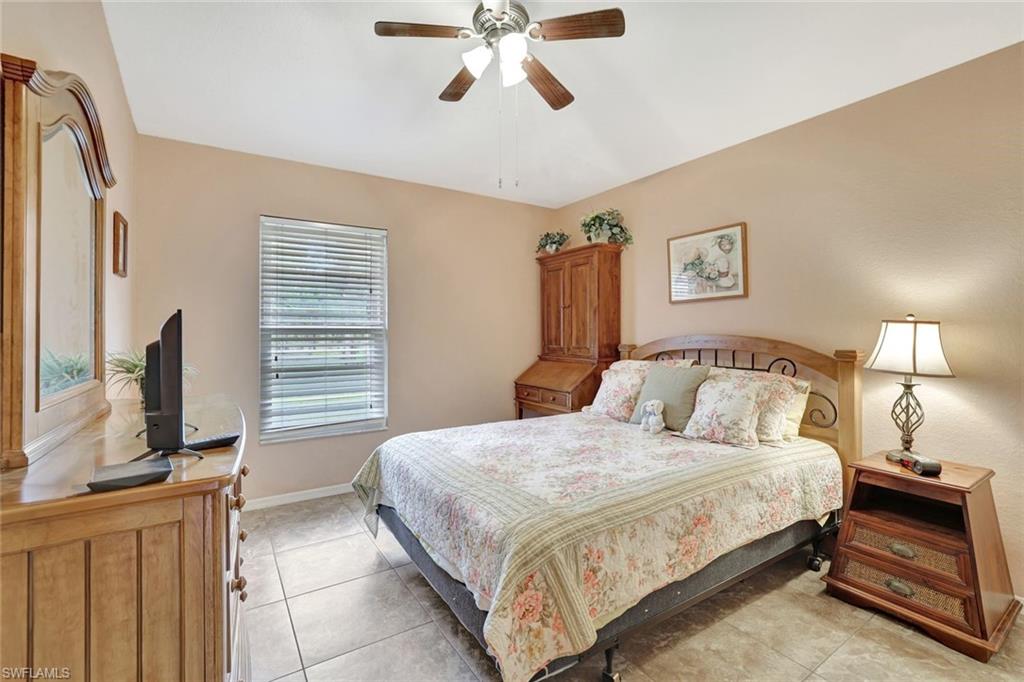 660 20th Street Southeast Naples, FL 34117 - Photo 10 of 17 Bedroom featuring light tile patterned floors and ceiling fan