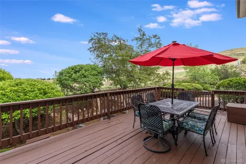 a view of balcony with wooden floor and outdoor seating
