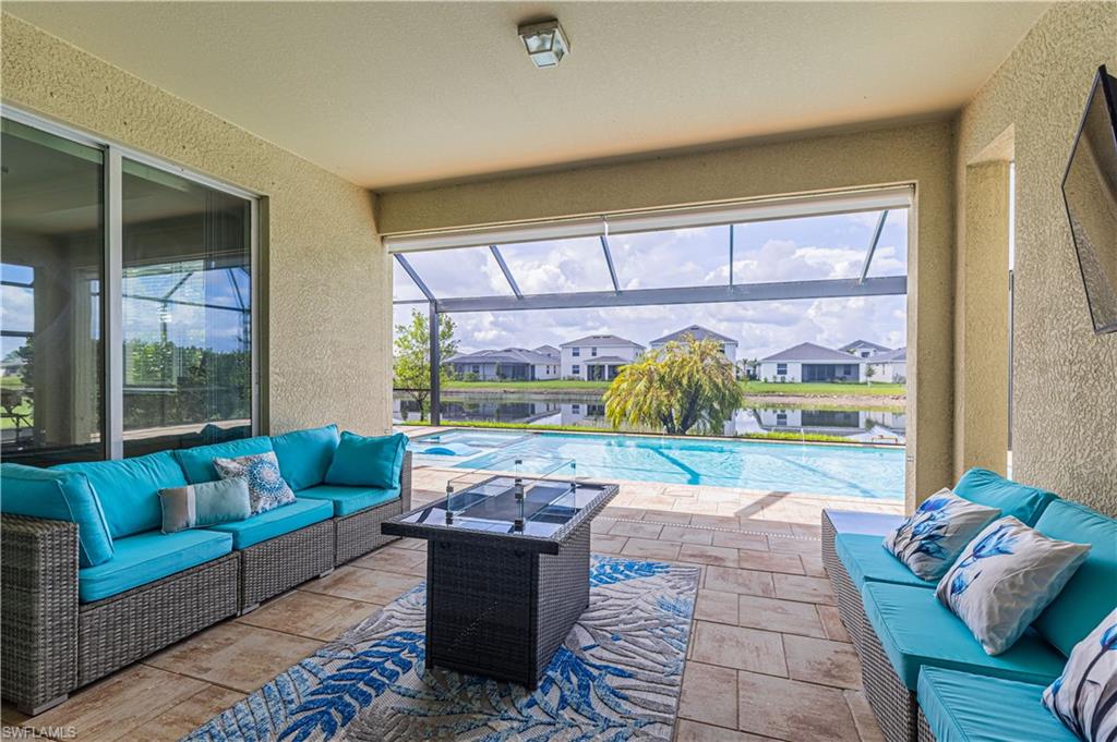 2079 Vermont Lane Naples, FL 34120 - Photo 1 of 13 a living room filled with furniture and a large window