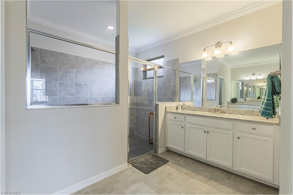 2079 Vermont Lane Naples, FL 34120 - Photo 11 of 13 a bathroom with a granite countertop sink mirror and a shower