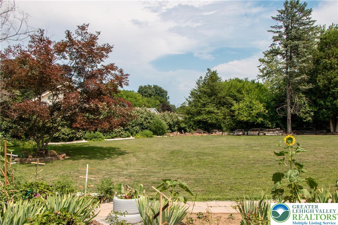 3582 Country Club Road Easton, PA 18045 - Photo 45 of 48 A spacious, yard invites outdoor activities, bordered by mature trees and lush plantings.