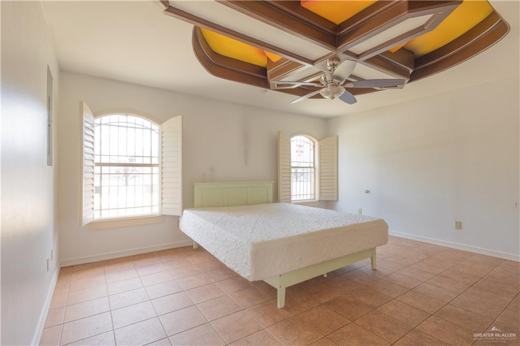 3909 Tulipan Street Mission, TX 78573 - Photo 9 of 16 a spacious bedroom with a bed and window