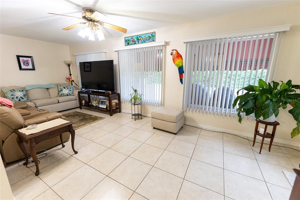 9074 Southeast 135th Loop Summerfield, FL 34491 - Photo 12 of 16 a living room with furniture and a flat screen tv