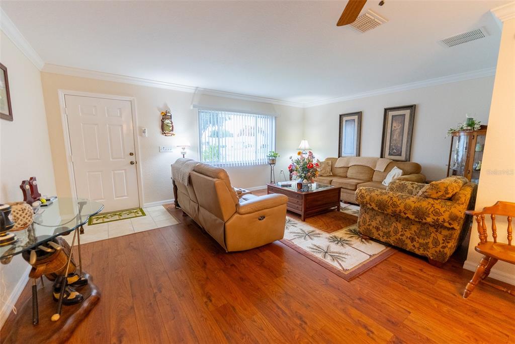 9074 Southeast 135th Loop Summerfield, FL 34491 - Photo 2 of 16 a living room with furniture and a wooden floor