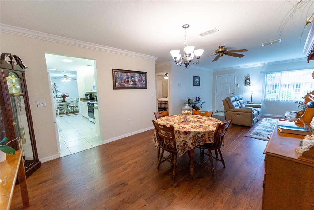 9074 Southeast 135th Loop Summerfield, FL 34491 - Photo 4 of 16 a view of a dining room with furniture and wooden floor