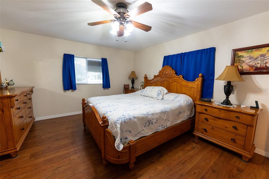 9074 Southeast 135th Loop Summerfield, FL 34491 - Photo 5 of 16 a bedroom with a bed and a dresser