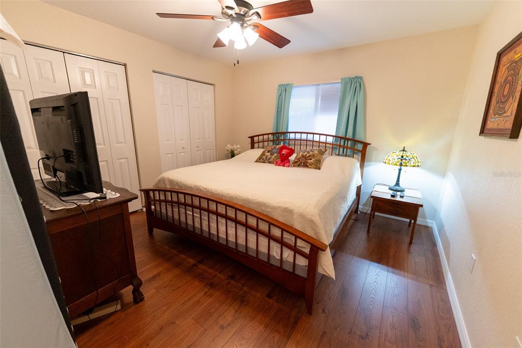 9074 Southeast 135th Loop Summerfield, FL 34491 - Photo 7 of 16 a bedroom with a bed and a mirror on the dresser