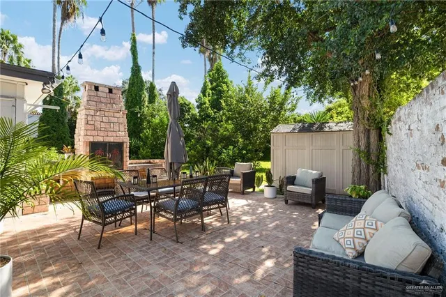 an outdoor sitting area with couch and a potted plant