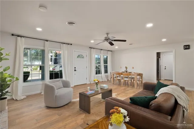 a living room with furniture and view of kitchen