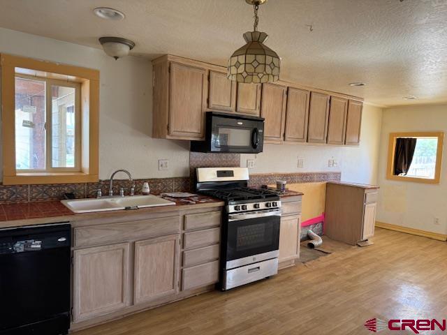 502 South Ash Street Cortez, CO 81321 - Photo 9 of 14 a kitchen with stainless steel appliances granite countertop a sink stove and refrigerator