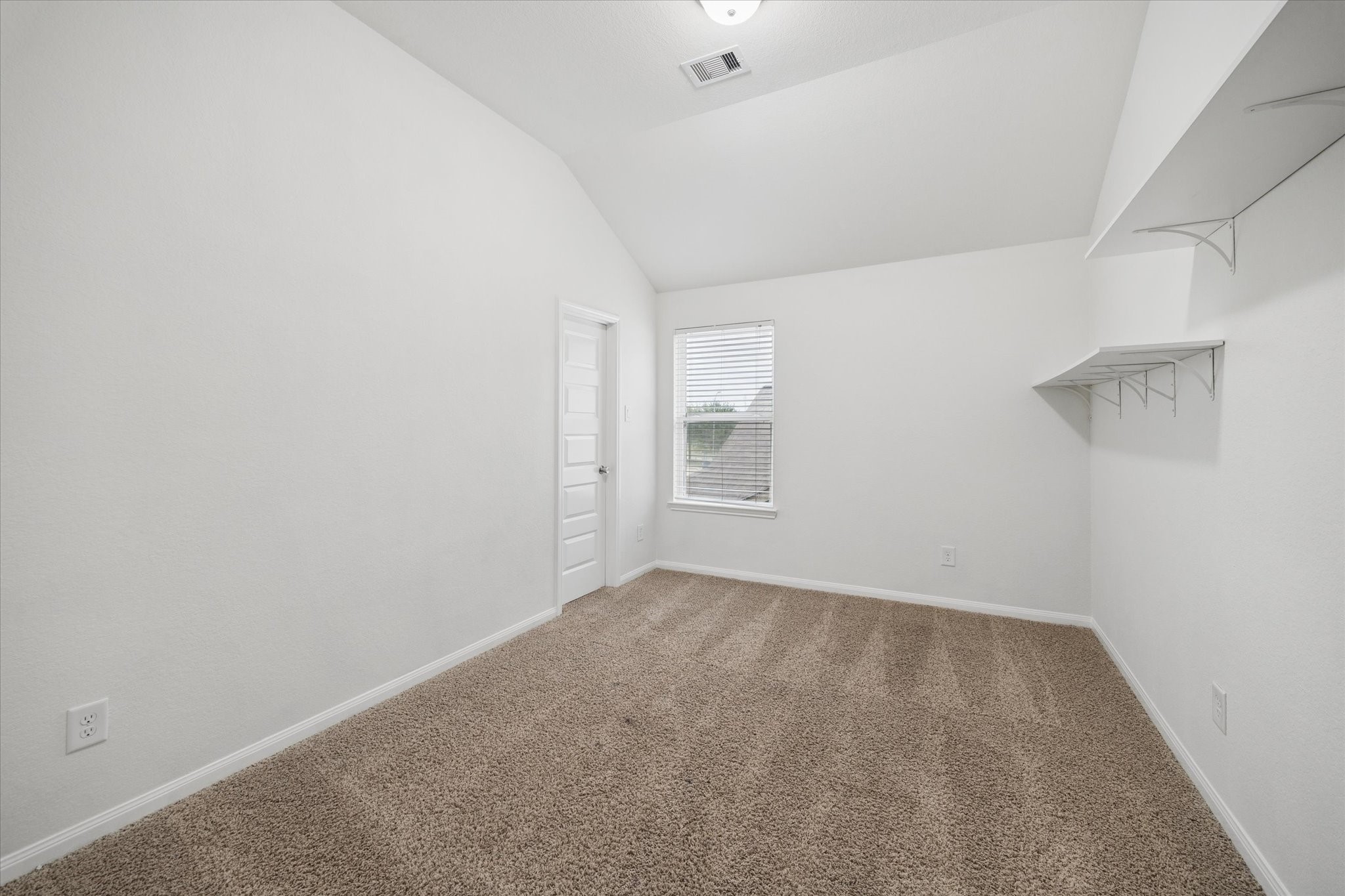 7015 Riata Hills Lane Spring, TX 77379 - Photo 24 of 33 Another secondary bedroom featuring soft carpet, abundant natural light, and a spacious layout—ideal for guests or children.