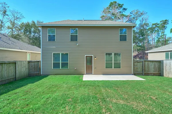 a view of house with a yard