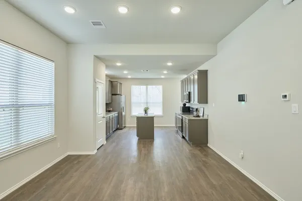 a view of large kitchen with a sink and wooden floor