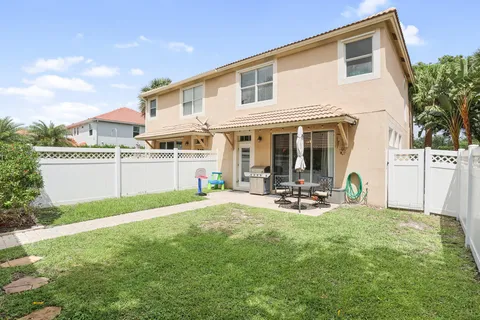 a view of a house with backyard porch and sitting area