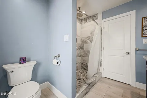 a bedroom with a bed and window with mirror