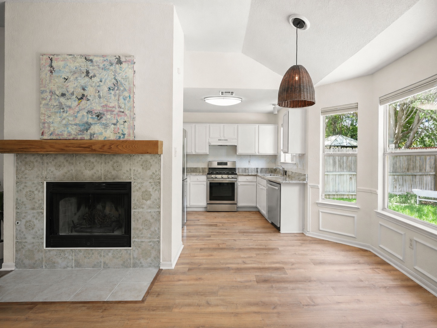 438 Katy Crossing Georgetown, TX 78626 - Photo 6 of 24 A well-lit interior features warm wood flooring leading to an inviting kitchen and sun-drenched dining area.