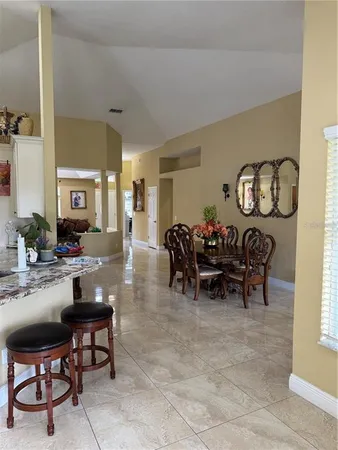 a view of a workspace with furniture and a ceiling fan