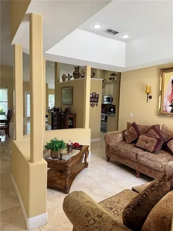 a living room with furniture and a chandelier