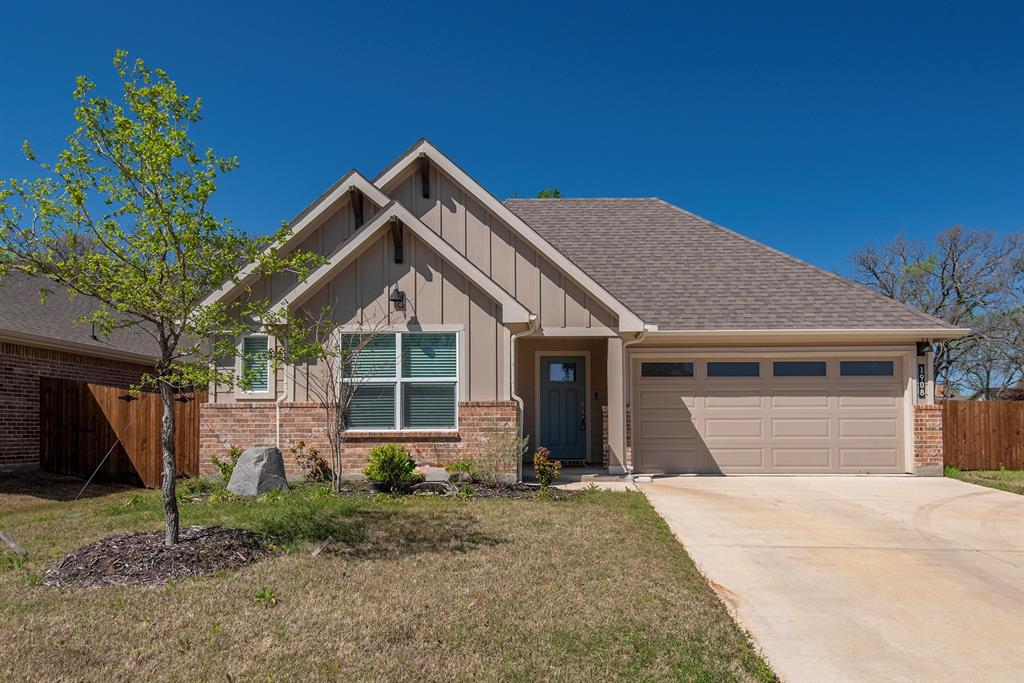 1908 Tawny Drive Denton, TX 76205 - Photo 1 of 1 a front view of a house with a yard and garage