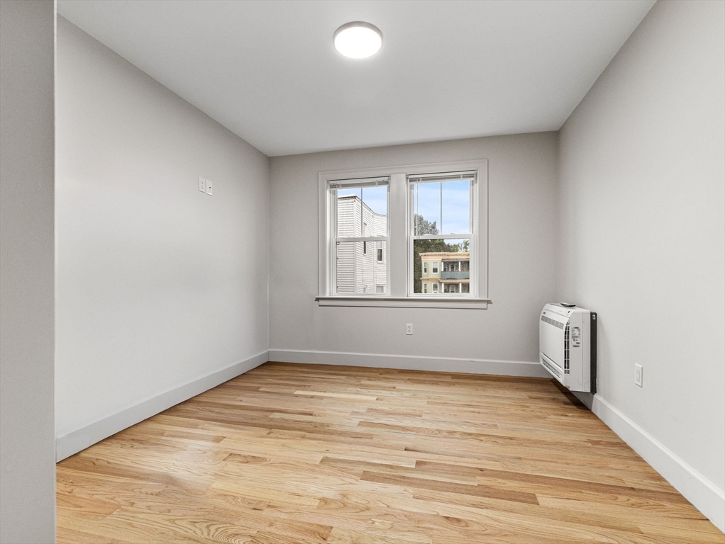 88 Wales Street, Unit 3 Boston, MA 02124 - Photo 11 of 18 a view of empty room with wooden floor and fan