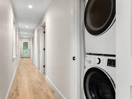 a view of a hallway with washer and dryer