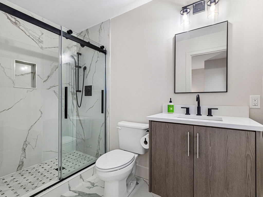 88 Wales Street, Unit 3 Boston, MA 02124 - Photo 14 of 18 a bathroom with a granite countertop sink toilet and shower