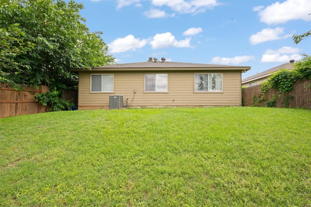 9936 Long Rifle Drive Fort Worth, TX 76108 - Photo 14 of 17 a front view of a house with a yard and garage