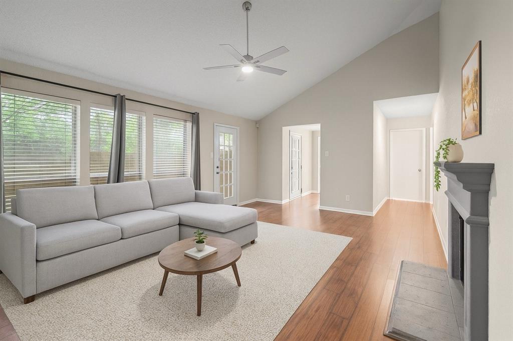 9936 Long Rifle Drive Fort Worth, TX 76108 - Photo 3 of 17 a living room with furniture a fireplace and a large window