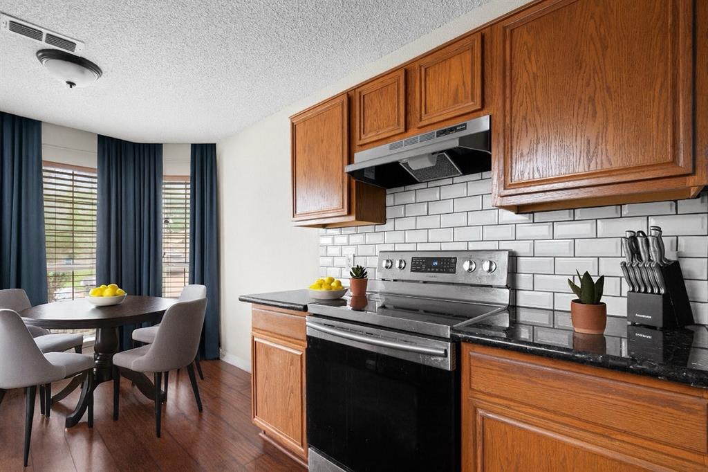9936 Long Rifle Drive Fort Worth, TX 76108 - Photo 5 of 17 a kitchen with granite countertop wooden cabinets and a stove top oven