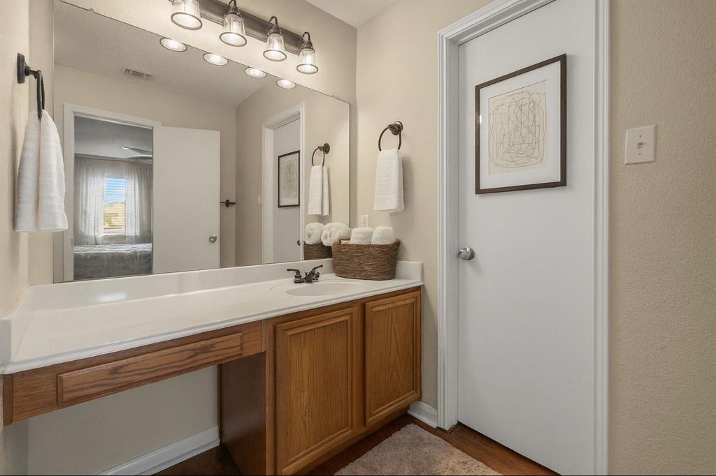 9936 Long Rifle Drive Fort Worth, TX 76108 - Photo 9 of 17 a bathroom with a sink a light fixture and a mirror