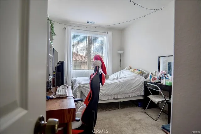 a bedroom with a bed and a chandelier