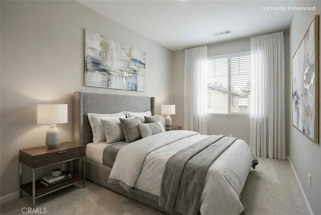 a bed sitting in a bedroom next to a window